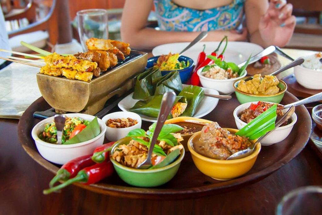 "Indonesian family-style meal with assorted traditional dishes"